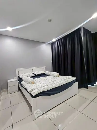 Modern bedroom with sleek design, featuring a cozy bed and elegant curtains, perfect for relaxation.