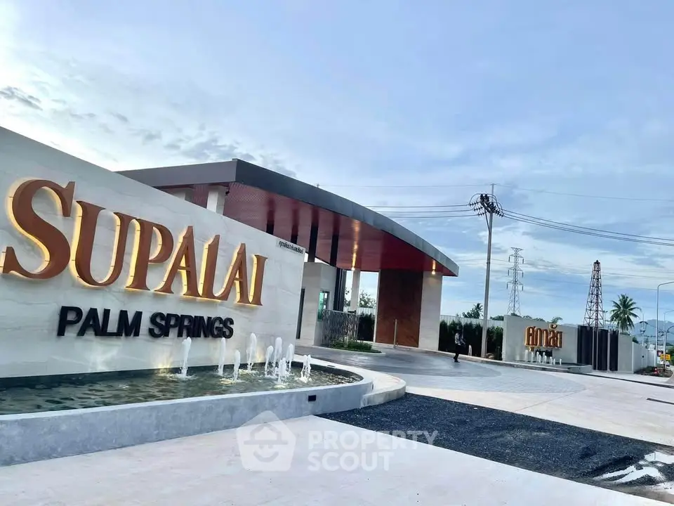 Luxurious entrance of Supalai Palm Springs with modern architecture and elegant signage.