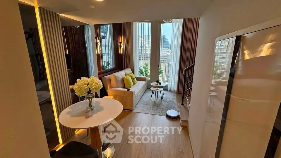 Modern living room with stylish decor and large windows offering city views