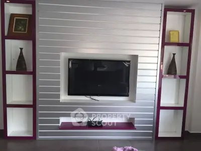 Modern living room with sleek TV wall unit and stylish shelving
