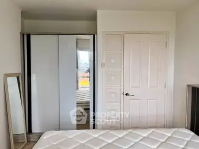 Modern bedroom with sleek wardrobe and comfortable mattress in a bright apartment.
