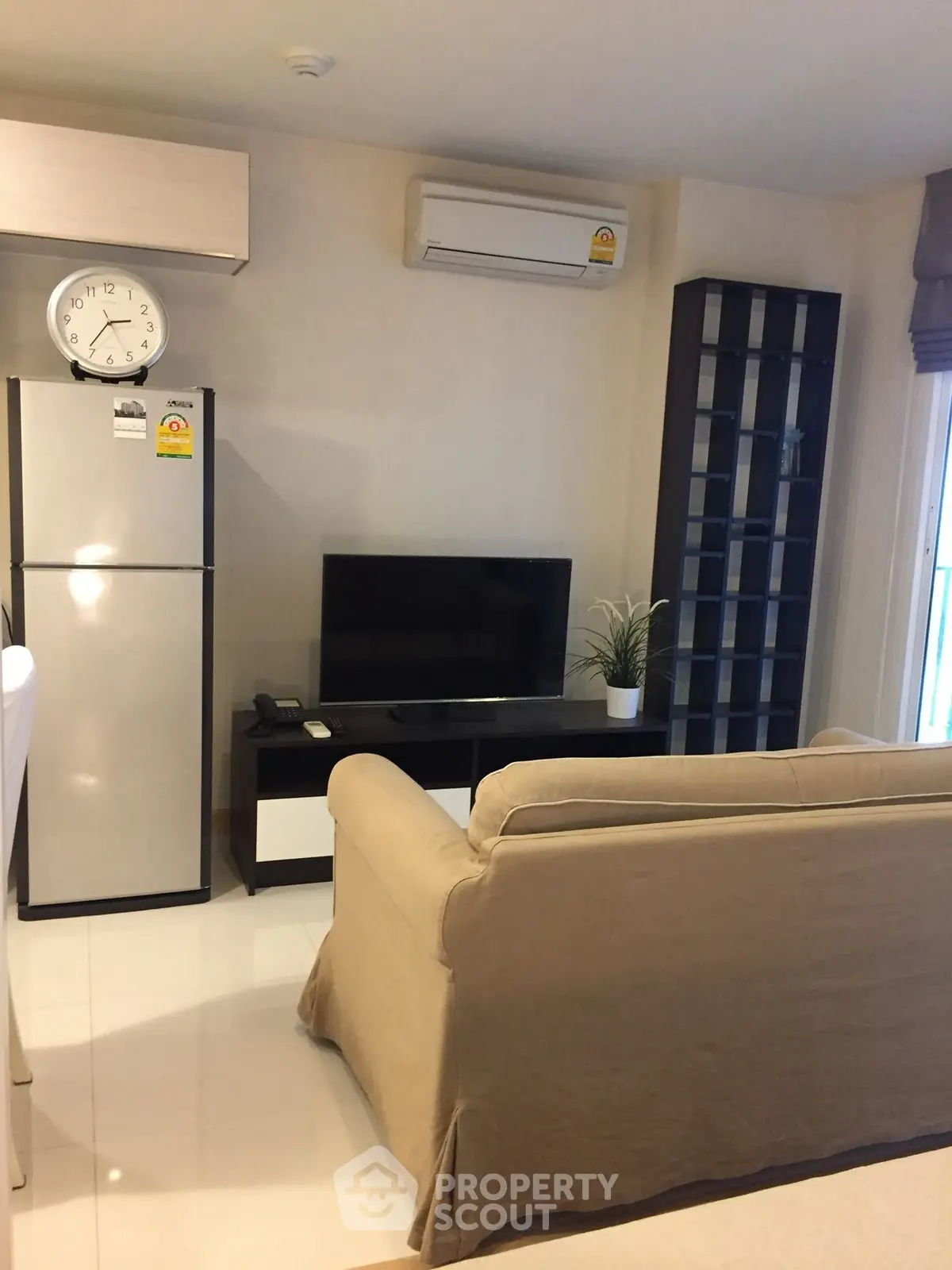 Cozy living room with modern appliances and stylish decor in a contemporary apartment.