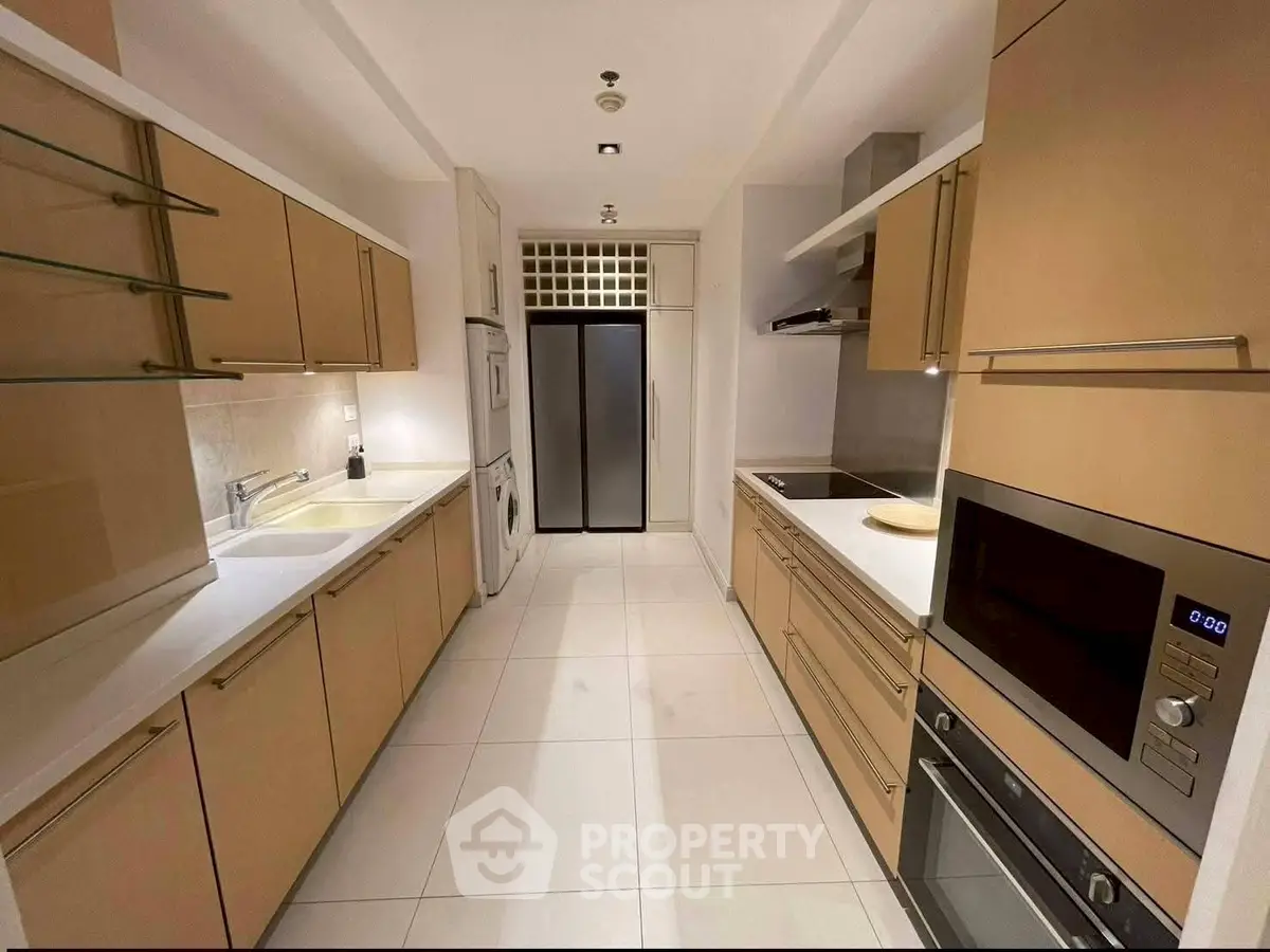 Modern kitchen with sleek cabinetry and built-in appliances in a spacious closed layout.