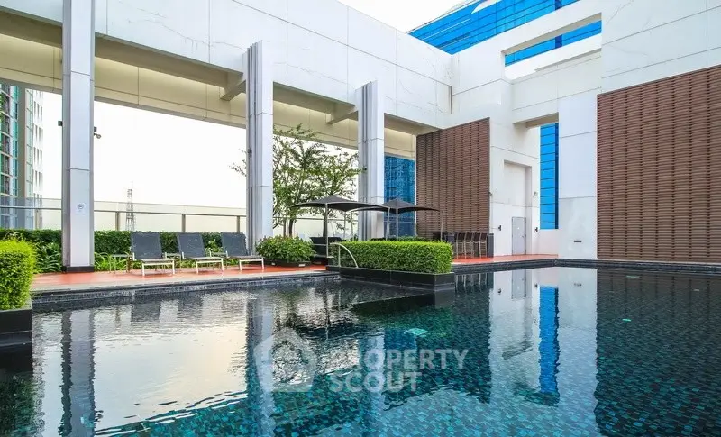 Luxurious rooftop pool with modern design and city views, perfect for relaxation and leisure.
