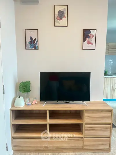 Modern living room with stylish TV stand and decor, perfect for cozy entertainment.