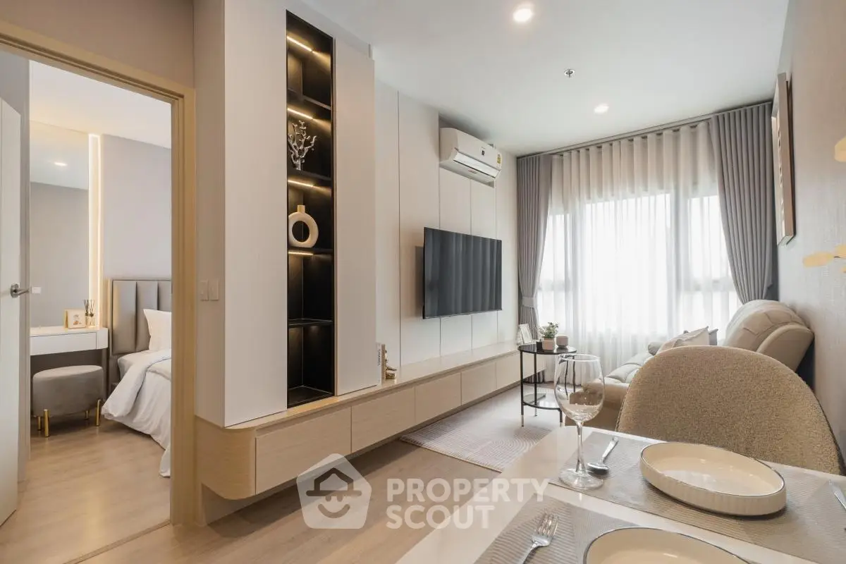 Modern living room with elegant decor and natural light, featuring a cozy dining area and stylish furnishings.