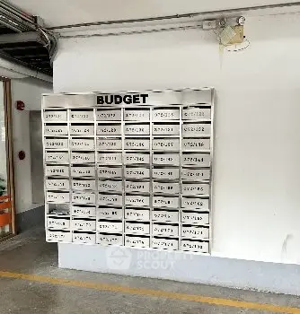 Apartment building mailboxes in a parking area showcasing organized mail slots.