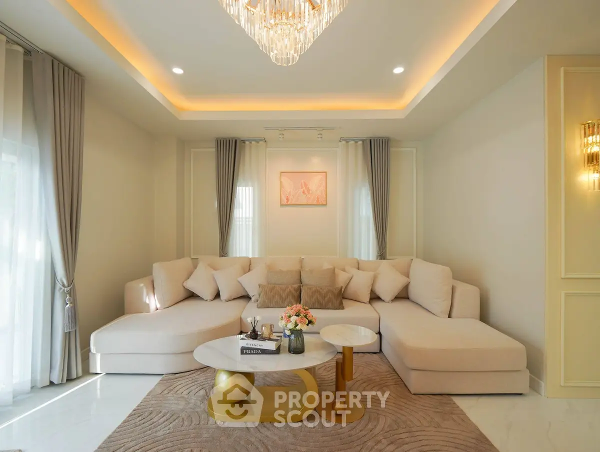 Luxurious living room with elegant chandelier and plush sectional sofa