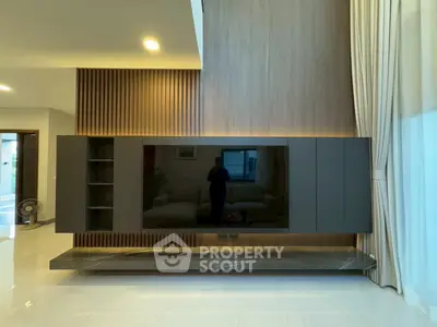 Modern living room with sleek TV unit and elegant curtains