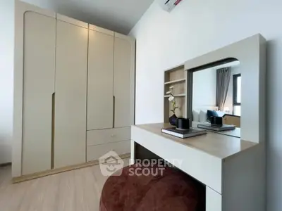 Modern bedroom with sleek wardrobe and stylish vanity set, perfect for contemporary living.