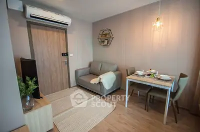 Cozy living room with modern decor and dining area in stylish apartment.