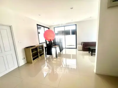 Spacious living room with modern furniture and large windows for natural light.