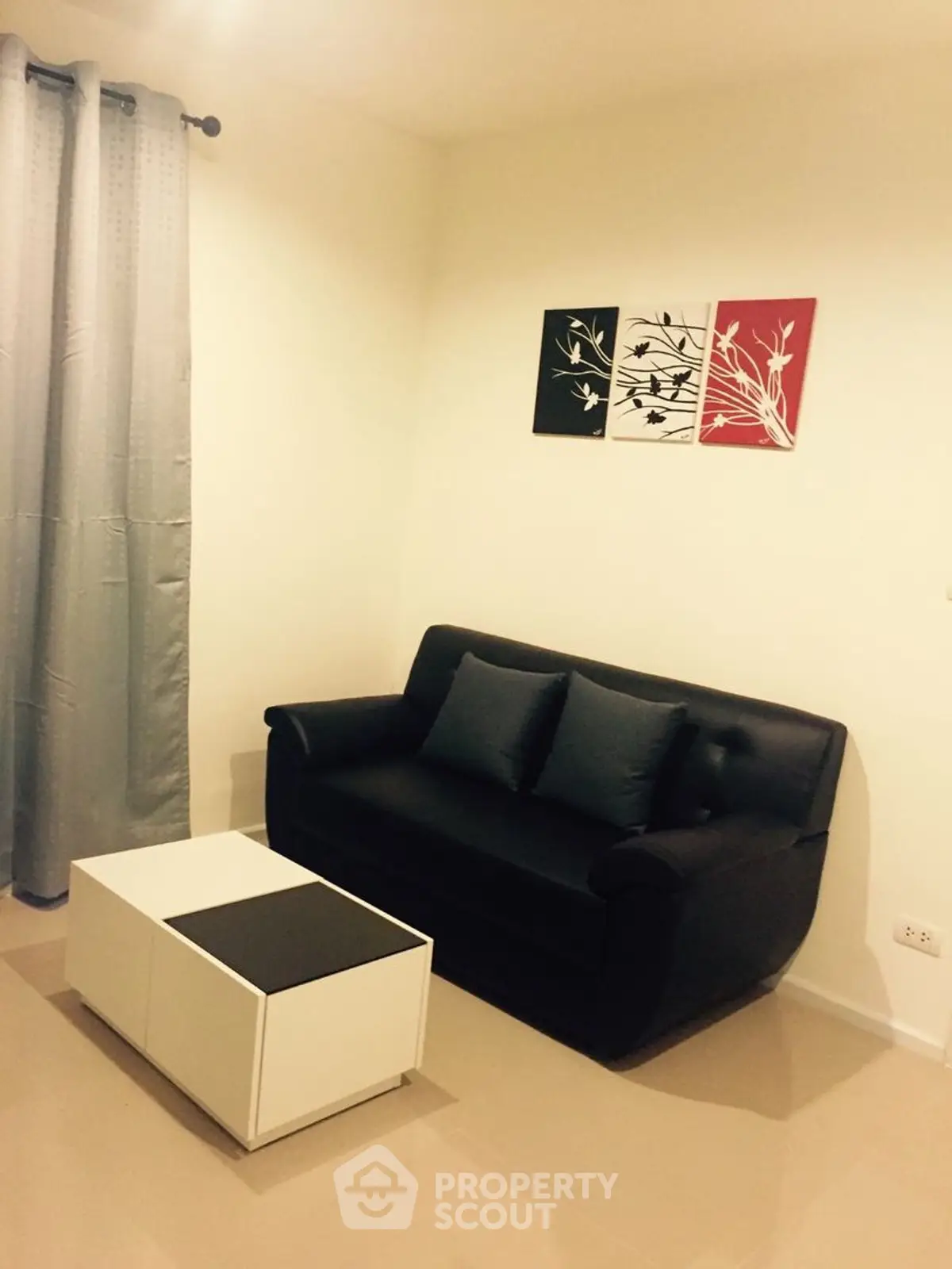 Cozy living room with modern black sofa and stylish wall art