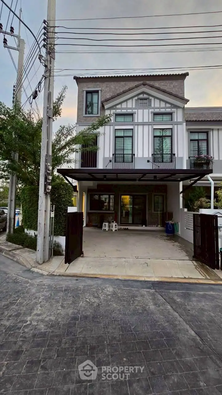 Charming two-story townhouse with modern facade and spacious driveway