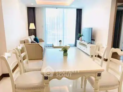 Elegant living room with dining area, featuring stylish furniture and abundant natural light.