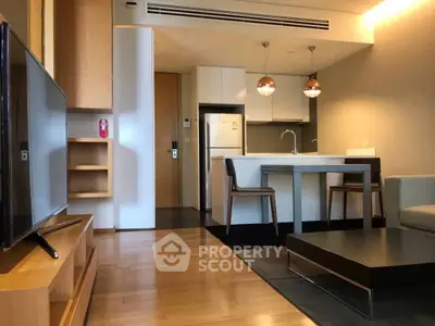 Modern open-plan living room with sleek kitchen and stylish furniture in a contemporary apartment.