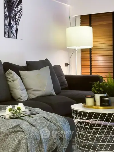 Stylish modern living room with cozy sofa, elegant decor, and ambient lighting for a welcoming atmosphere.