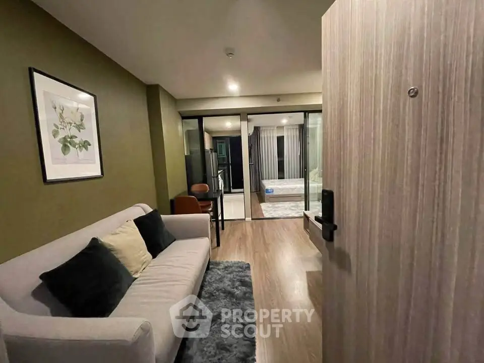 Modern living room with stylish decor and cozy ambiance, featuring a plush sofa and elegant artwork.