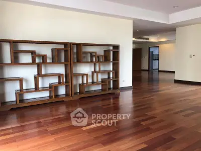 Spacious living room with elegant wooden flooring and modern shelving unit