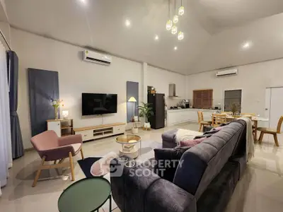 Spacious modern living room with open kitchen, stylish furniture, and ambient lighting