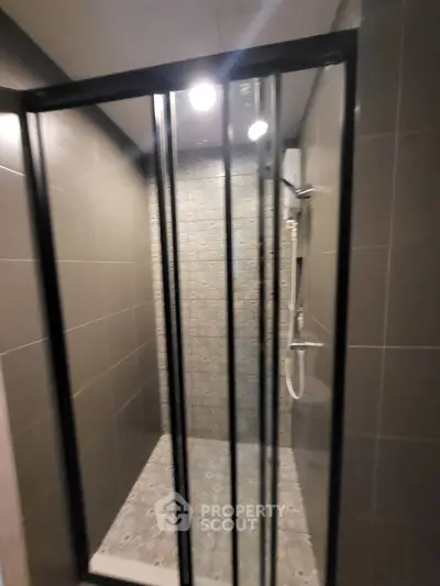 Modern bathroom with sleek shower enclosure and stylish tile design.