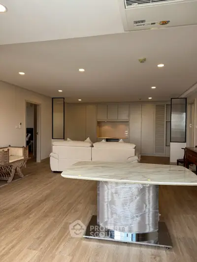 Spacious modern living room with open kitchen and elegant marble table