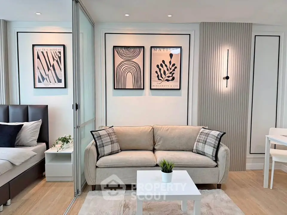 Modern living room with stylish decor and cozy seating in a contemporary apartment.