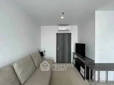 Modern living room with sleek furniture and air conditioning, perfect for urban living.