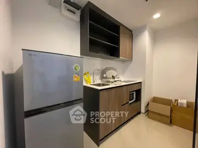 Modern kitchen with sleek cabinets and appliances in compact layout