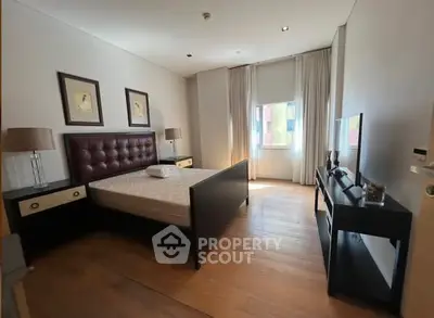 Spacious bedroom with modern furnishings and natural light