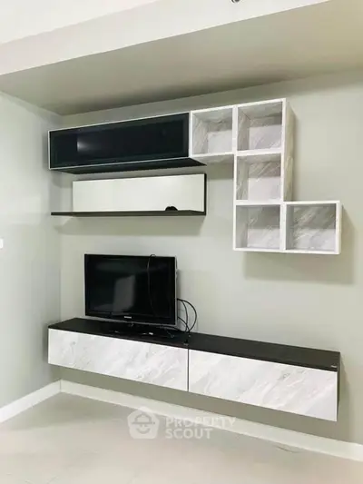 Modern living room with sleek wall-mounted TV unit and stylish shelving