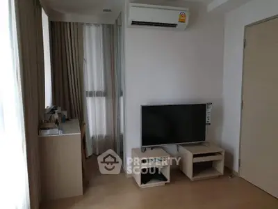 Modern living room with TV and air conditioning in a cozy apartment.