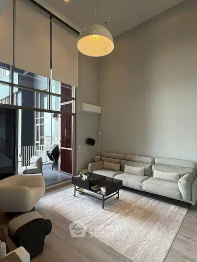 Spacious modern living room with high ceilings and elegant decor