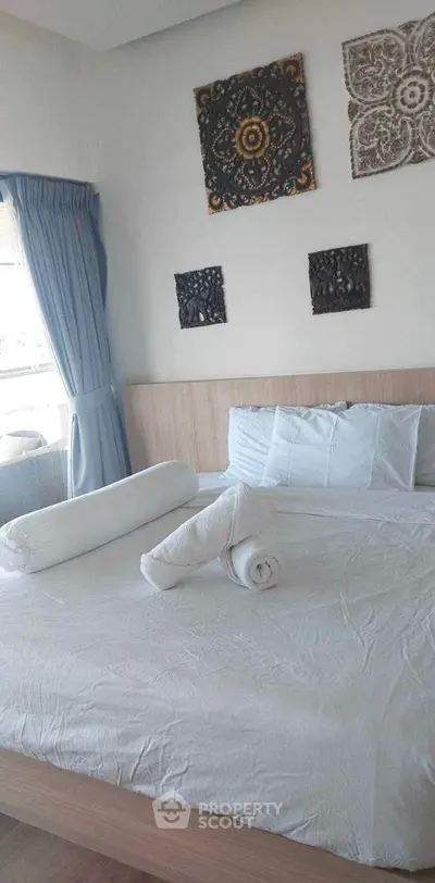 Cozy bedroom with stylish wall decor and natural light