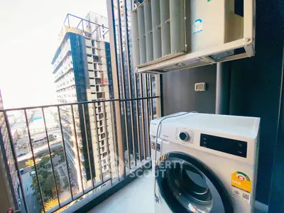 Modern balcony with washing machine and city view in high-rise apartment