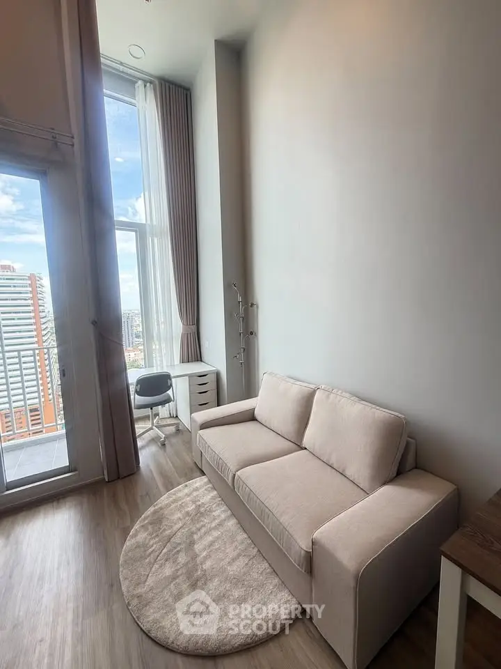 Modern living room with high ceiling and city view balcony in luxury apartment.