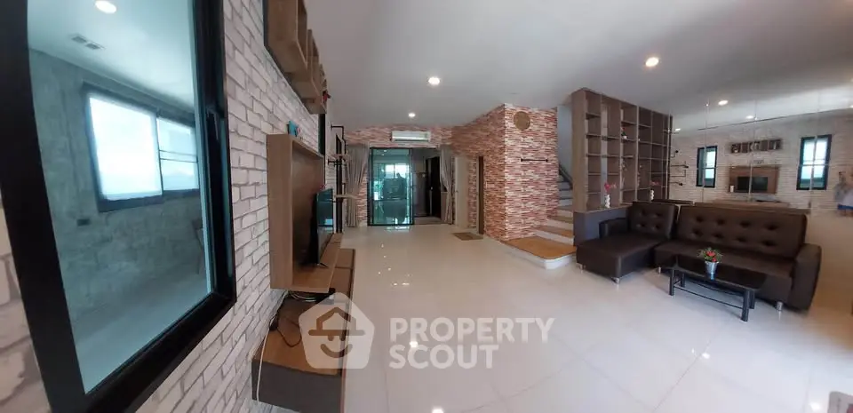 Spacious modern living room with stylish brick walls and sleek furniture