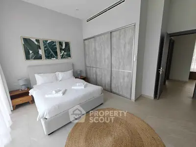 Modern bedroom with stylish decor and large closet in a luxury apartment.