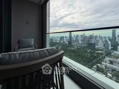 Luxurious high-rise balcony with stunning cityscape view and comfortable seating.