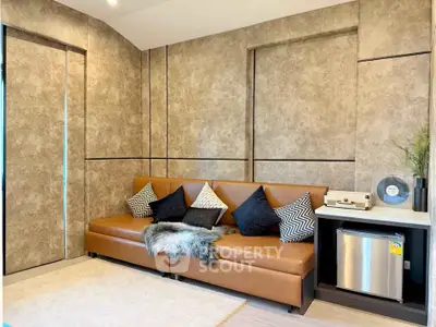 Modern living room with stylish brown leather sofa and chic decor