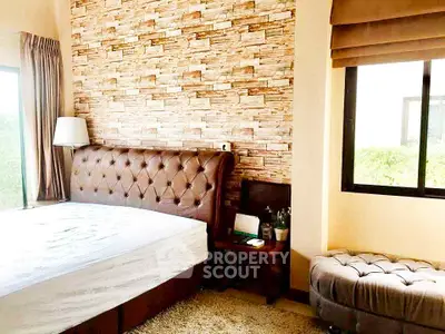 Luxurious bedroom with tufted headboard and stylish stone accent wall
