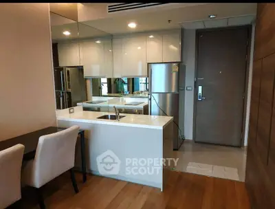 Modern kitchen with sleek design, featuring stainless steel appliances and open layout for stylish living.