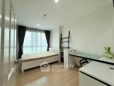 Modern bedroom with study area and large window offering city views