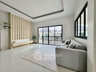 Spacious modern living room with large windows and elegant decor