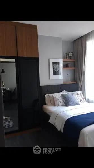 Modern bedroom with stylish decor and ample natural light