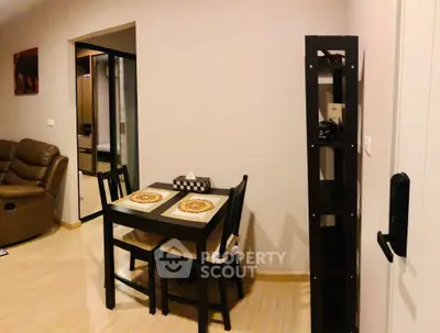 Cozy dining area with modern furniture and warm lighting in a stylish apartment.