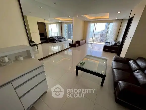 Spacious modern living room with sleek furniture and stunning city view.