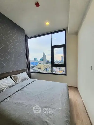 Modern bedroom with city view and stylish decor in high-rise apartment.
