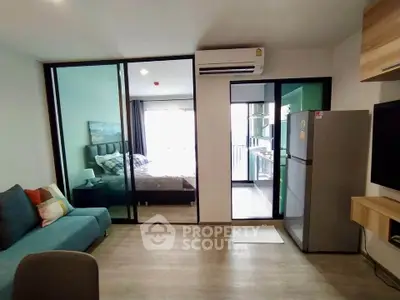Modern apartment with open layout, featuring a cozy living area and bedroom with balcony access.