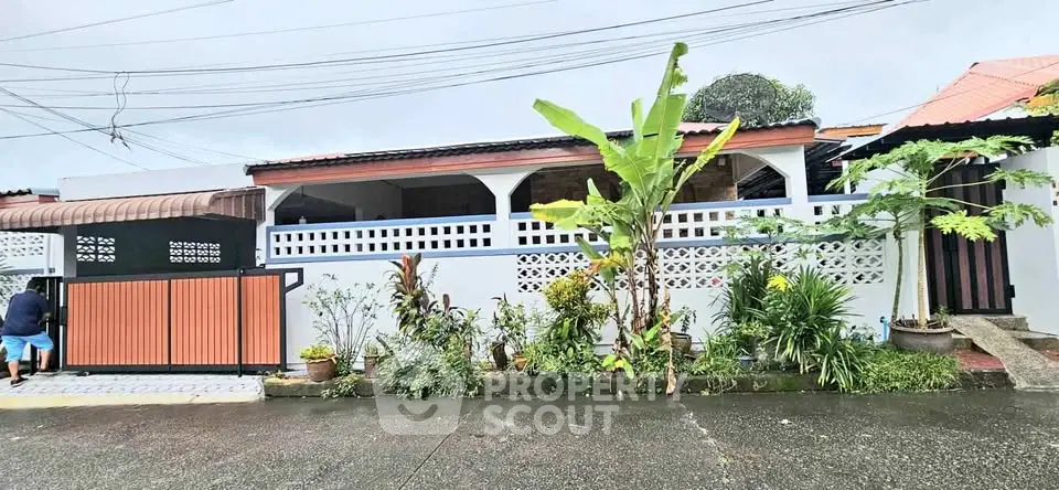 Charming single-story home with lush garden and gated entrance in a serene neighborhood.